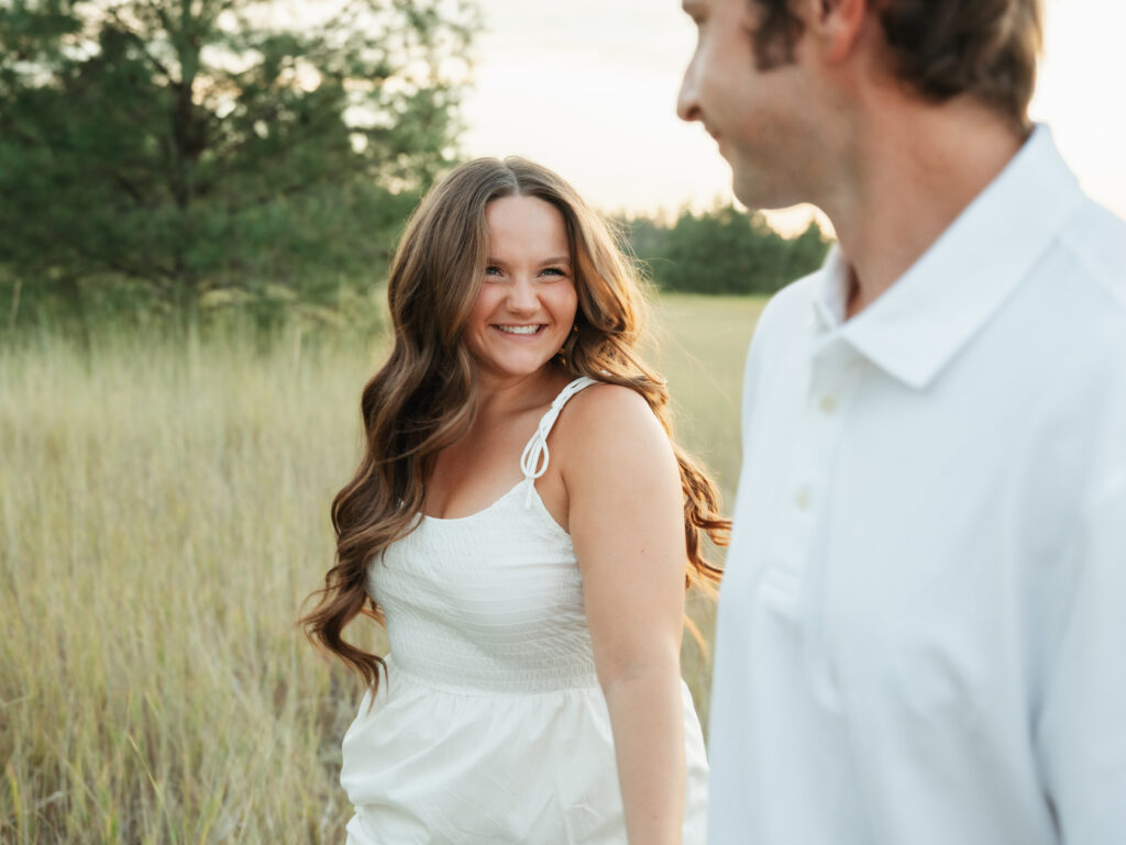 A relaxed late summer engagement session in East Spokane featuring golden fields, natural light, and an outdoors-loving couple.