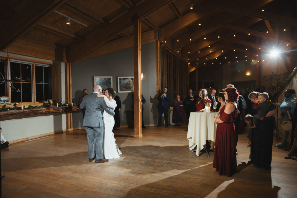 A cozy November wedding at Sleeping Lady Mountain Resort in Leavenworth, WA featuring DIY florals, a bridal cape, and mountain views.