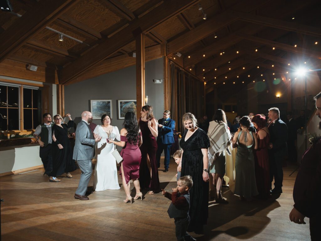 A cozy November wedding at Sleeping Lady Mountain Resort in Leavenworth, WA featuring DIY florals, a bridal cape, and mountain views.