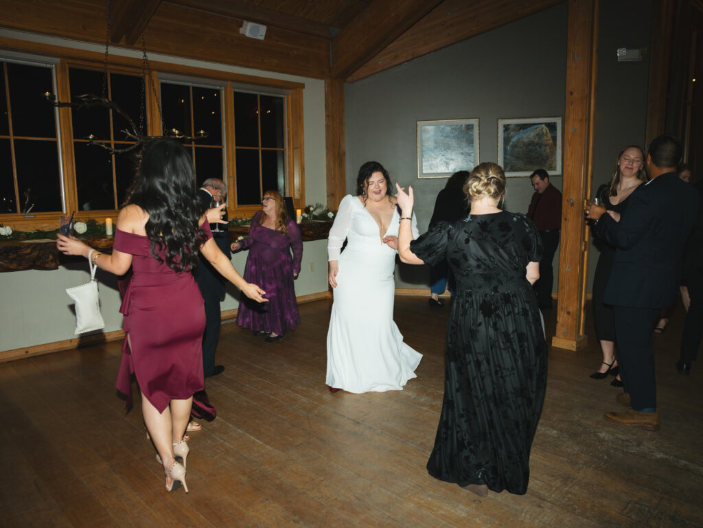 A cozy November wedding at Sleeping Lady Mountain Resort in Leavenworth, WA featuring DIY florals, a bridal cape, and mountain views.