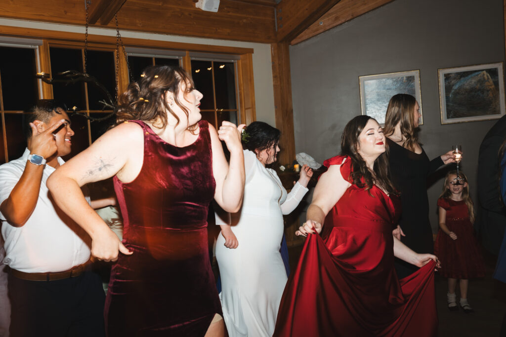 A cozy November wedding at Sleeping Lady Mountain Resort in Leavenworth, WA featuring DIY florals, a bridal cape, and mountain views.