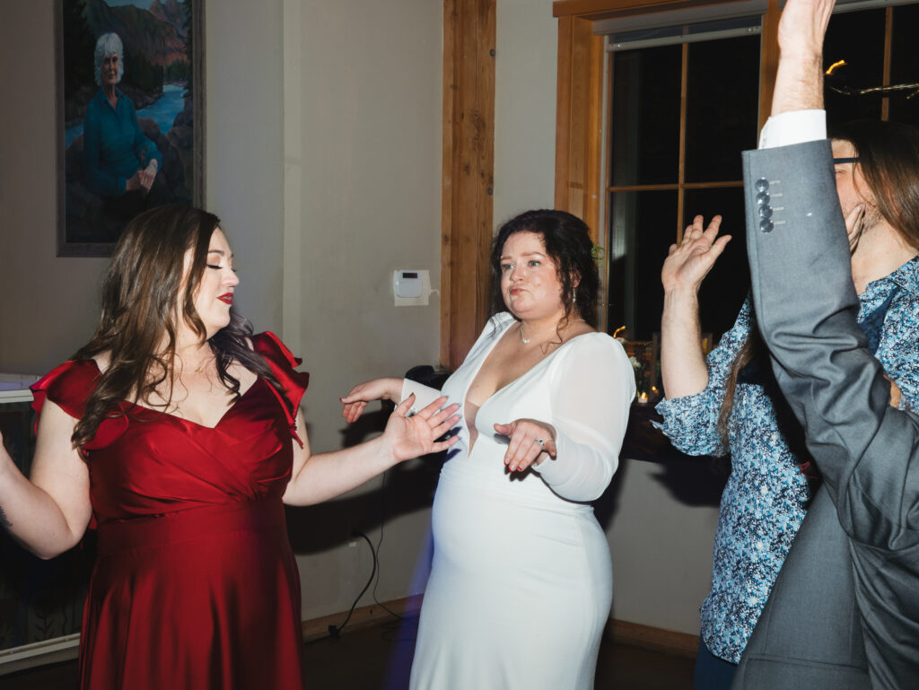 A cozy November wedding at Sleeping Lady Mountain Resort in Leavenworth, WA featuring DIY florals, a bridal cape, and mountain views.