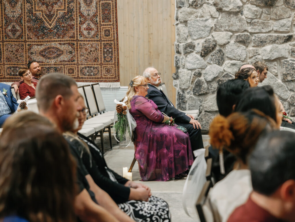 A cozy November wedding at Sleeping Lady Mountain Resort in Leavenworth, WA featuring DIY florals, a bridal cape, and mountain views.