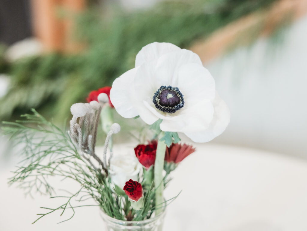A cozy November wedding at Sleeping Lady Mountain Resort in Leavenworth, WA featuring DIY florals, a bridal cape, and mountain views.