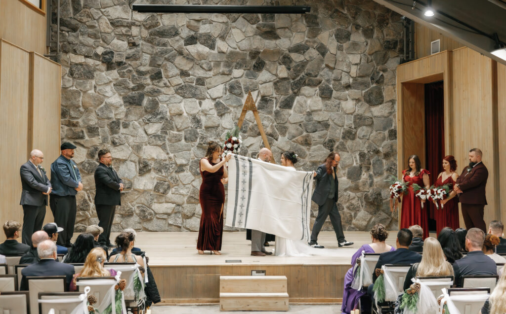 A cozy November wedding at Sleeping Lady Mountain Resort in Leavenworth, WA featuring DIY florals, a bridal cape, and mountain views.